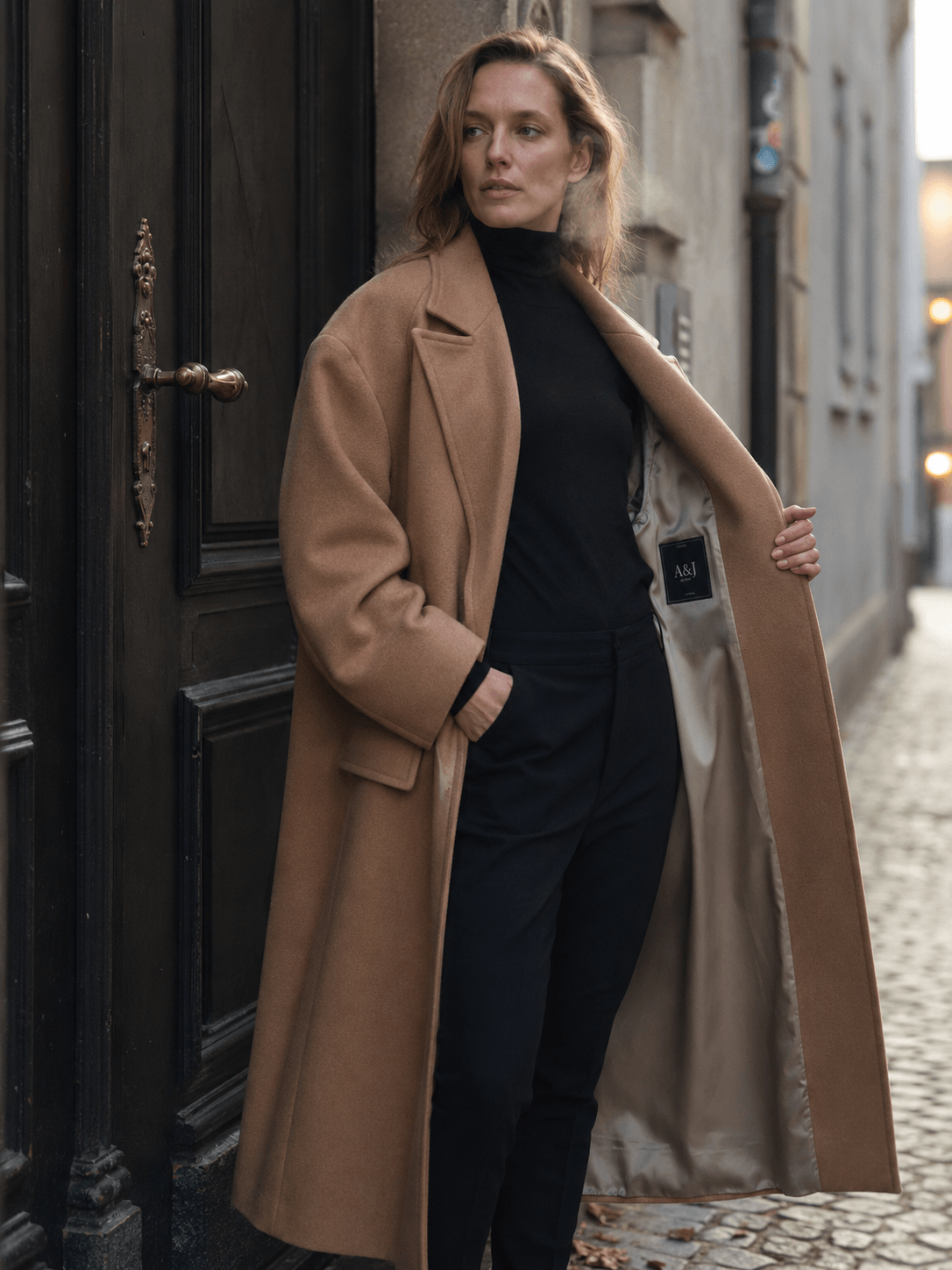 Wholesale wool coat manufacturer 700gsm melton wool longline coat worn by model on Berlin Mitte cobblestone street